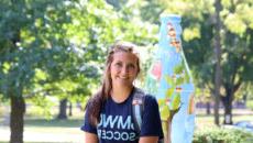 Smiling student in front of Rooney Library